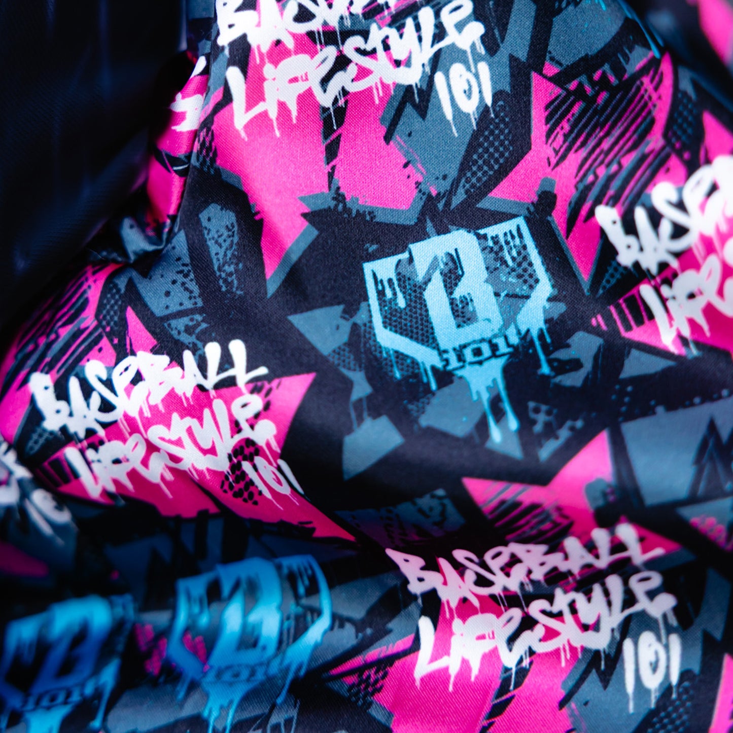 Fabric with 'Baseball Lifestyle 101' text and graphics in pink, black, and blue.