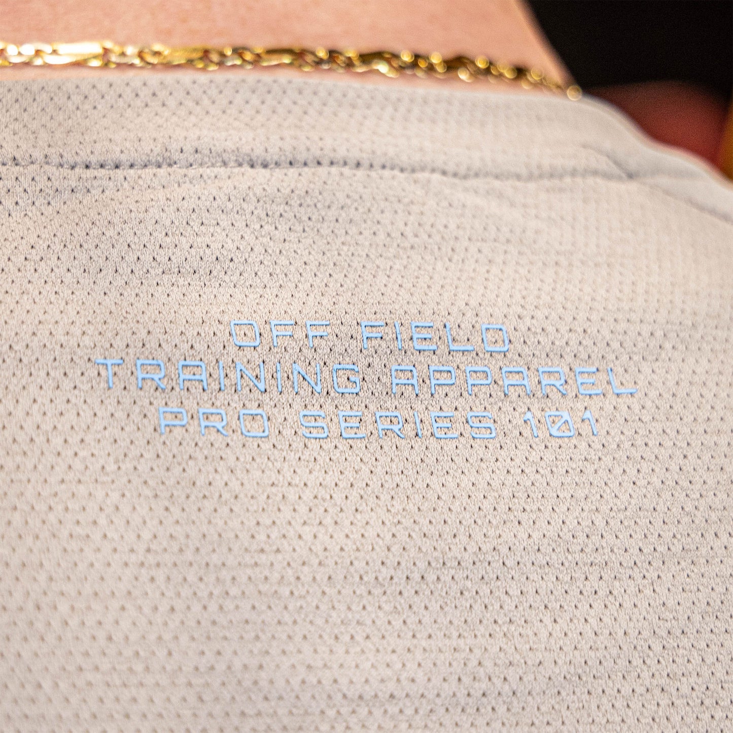 athlete wearing gray performance shirt