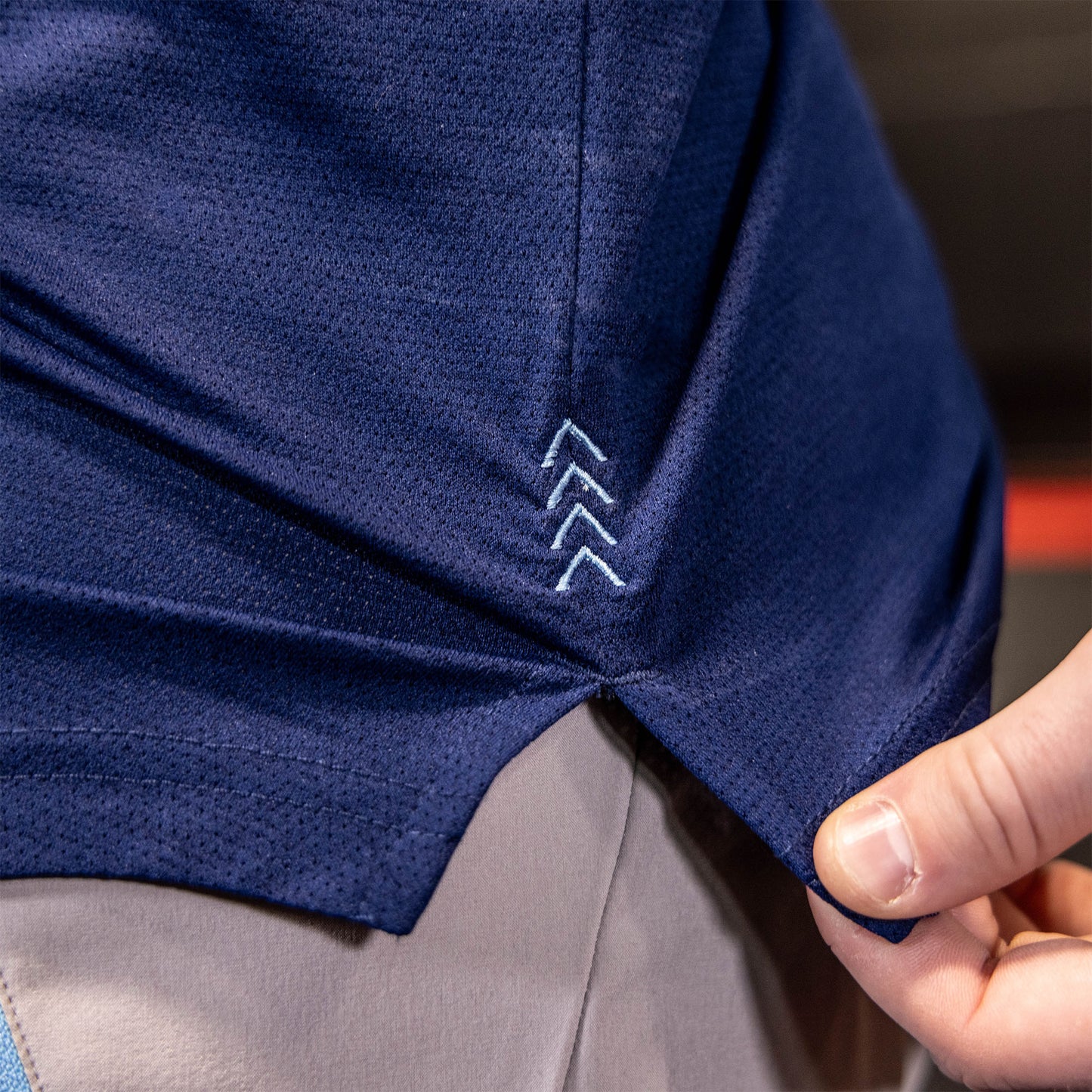 athlete wearing navy athletic shirt