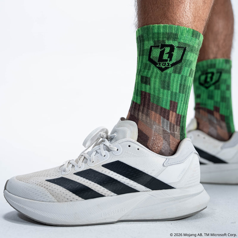 Adult model wearing multi-color socks with "BL101 X Minecraft Performance 3-Pack" design