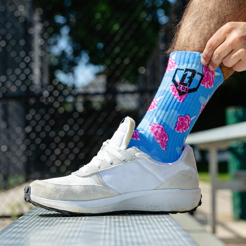 Adult model wearing multi-color socks with "Cotton Candy Performance  3-Pack" design