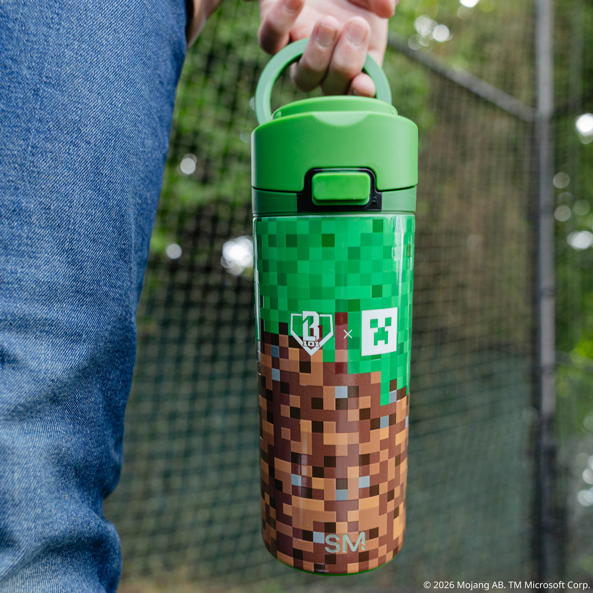 Multi-Color Mesa Loop Minecraft Grass Block water bottle with covered straw — lifestyle