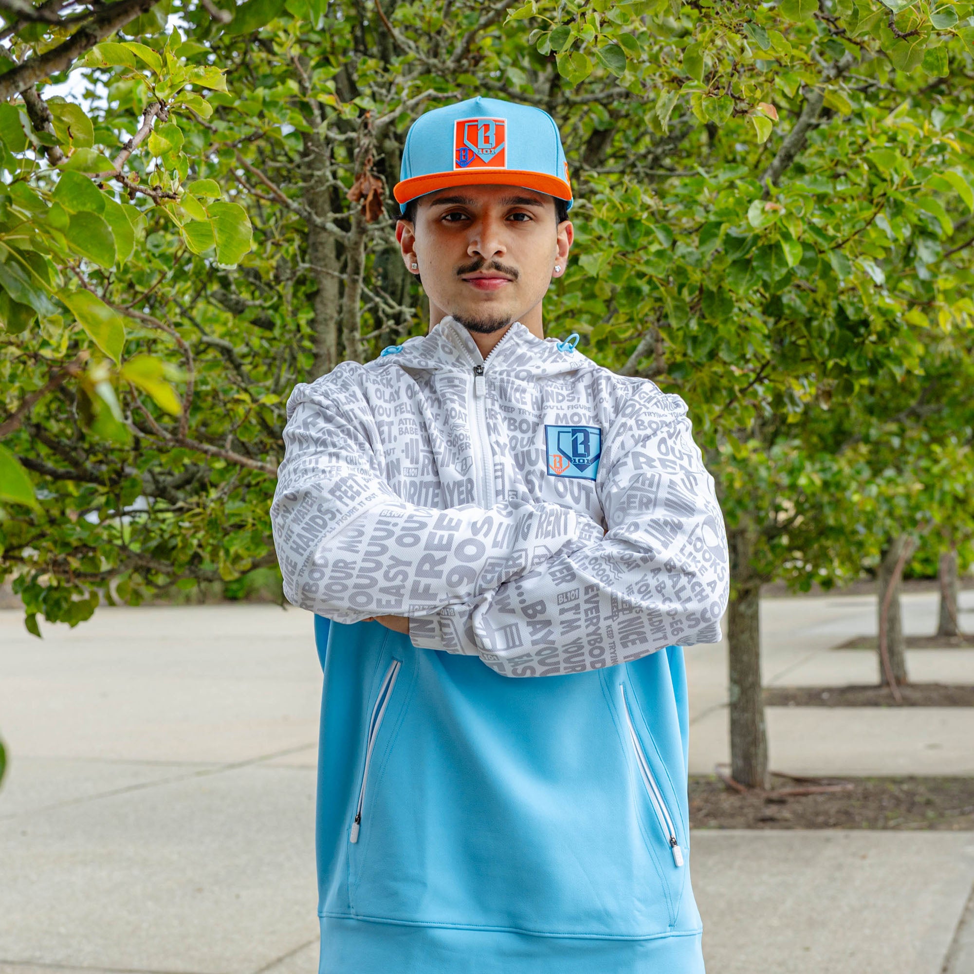 Adult model wearing blue hat with "Trash Talk" design