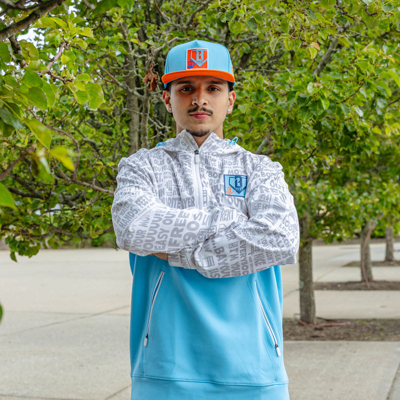 Adult model wearing blue hat with "Trash Talk" design