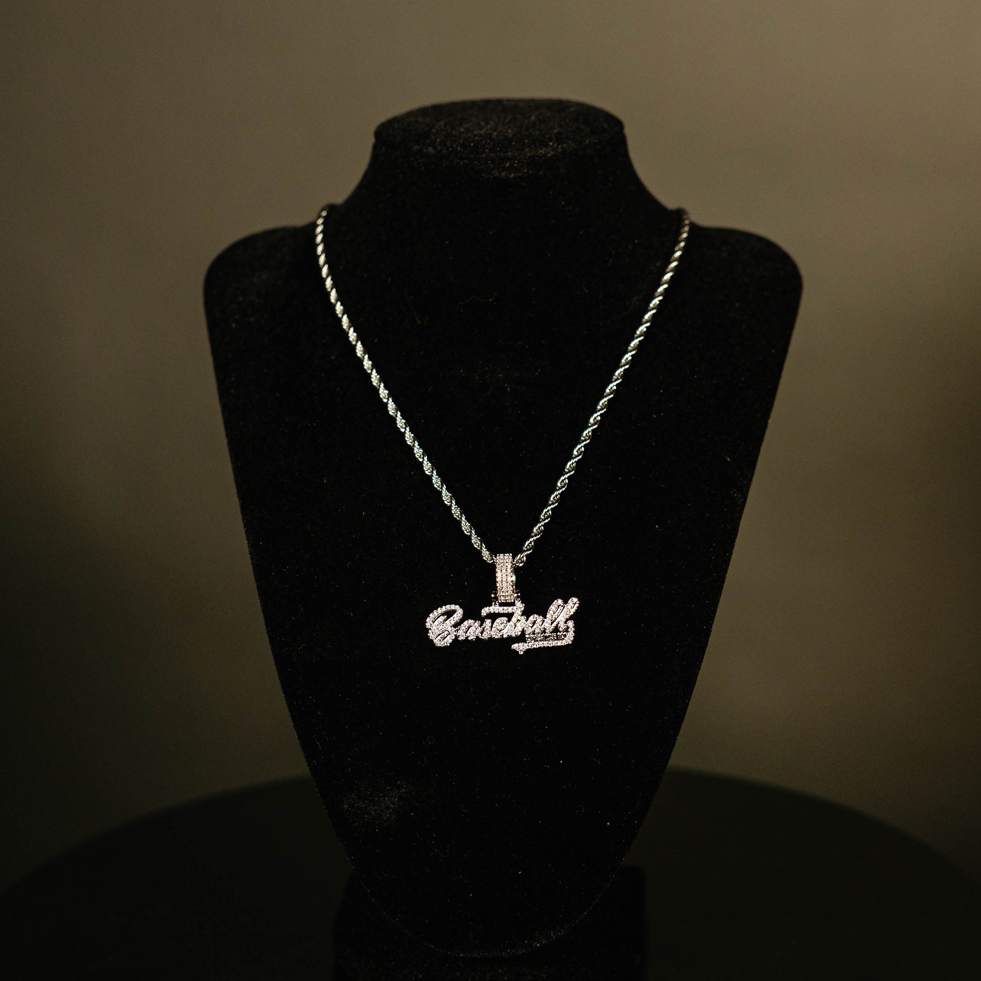 White Gold BL101 Established necklace hanging on a display stand against a black background