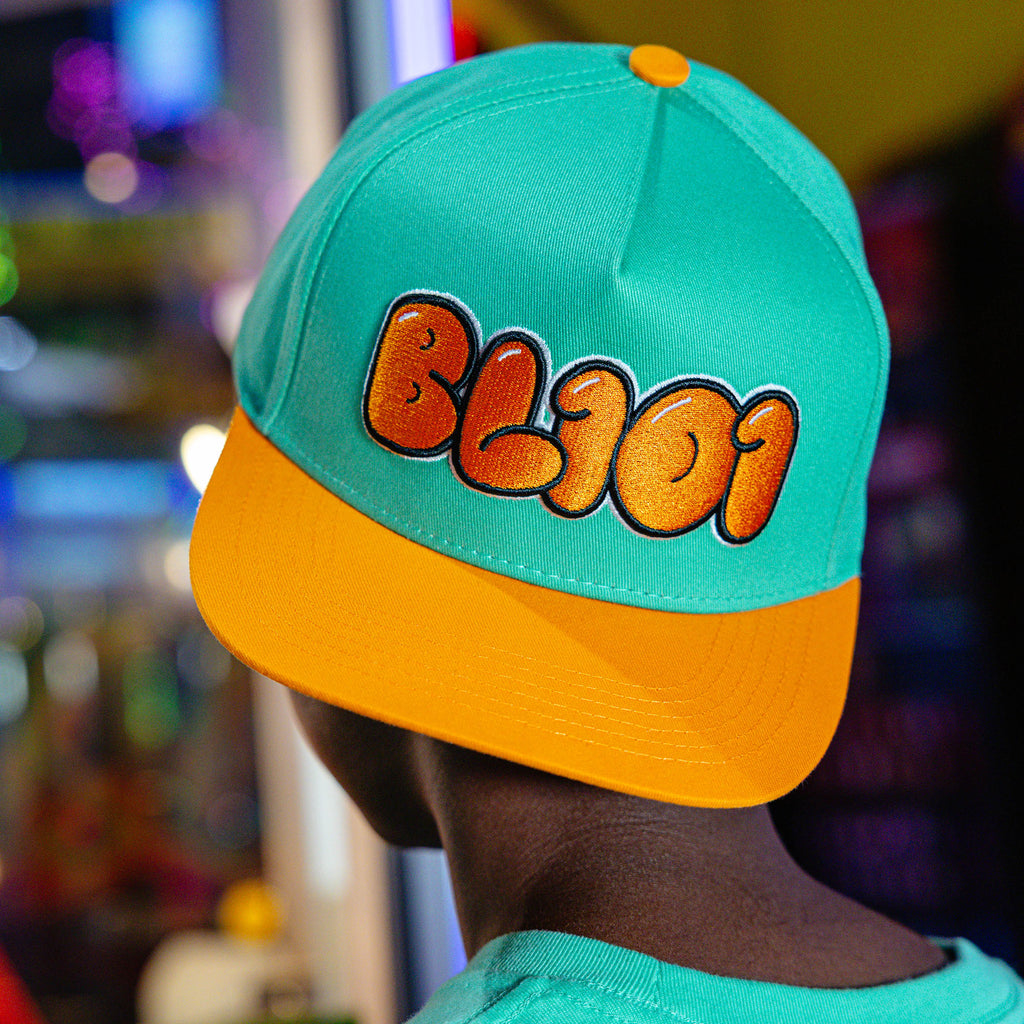 Adult model wearing Cotton Candy Tangerine Freeze hat
