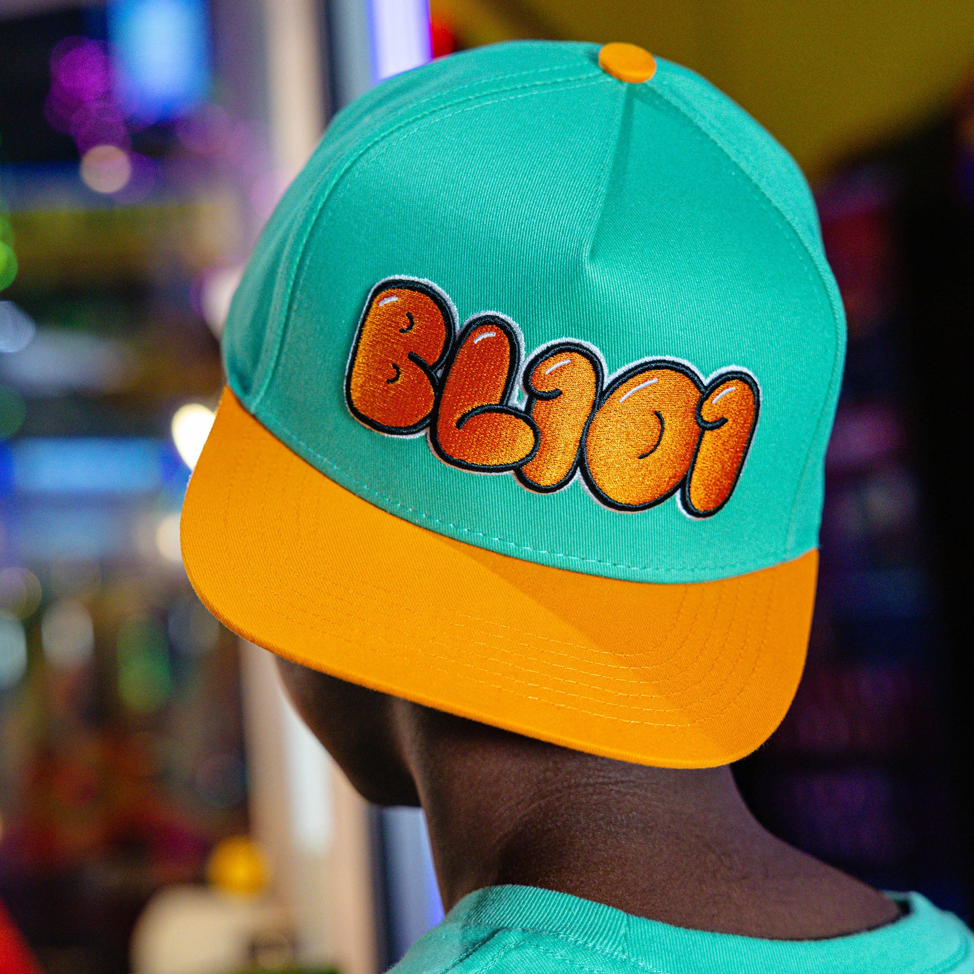 Adult model wearing Cotton Candy Tangerine Freeze hat