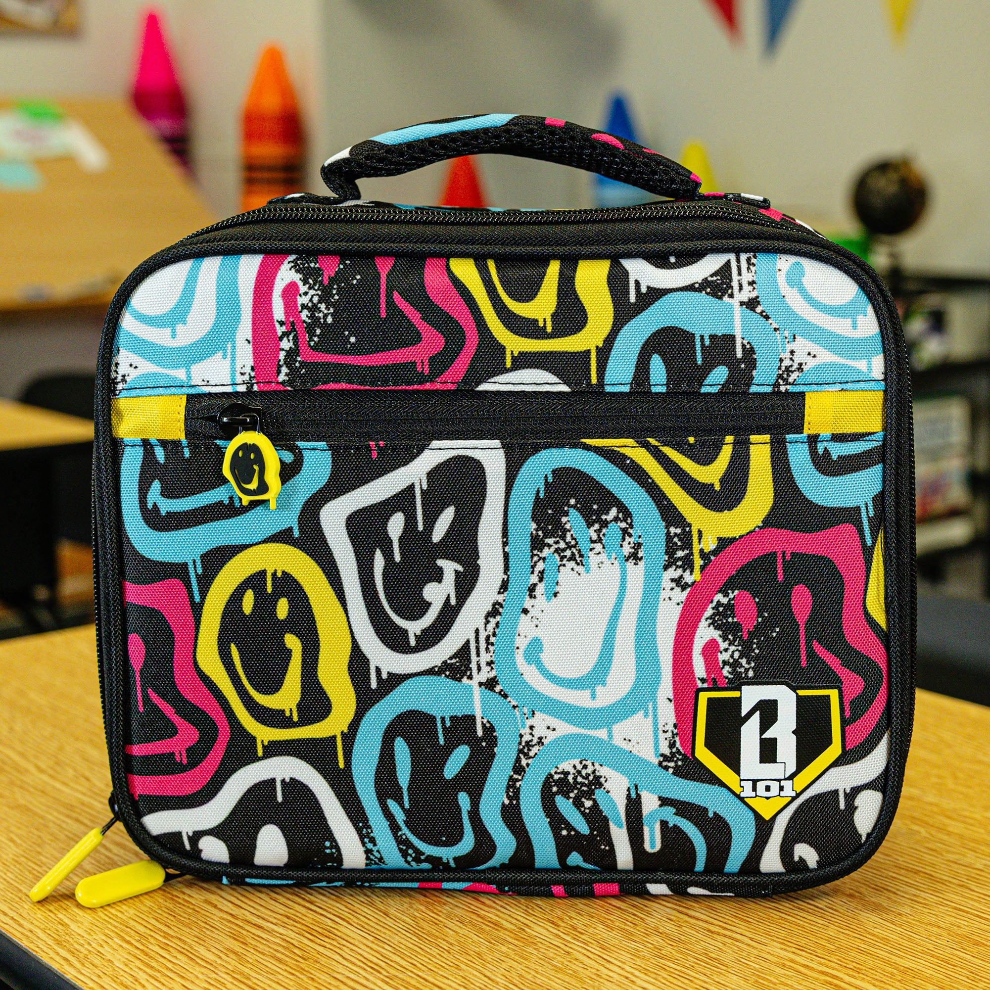 Adult model wearing multi-color lunch box with "Smiley Slugger SZN 2" design