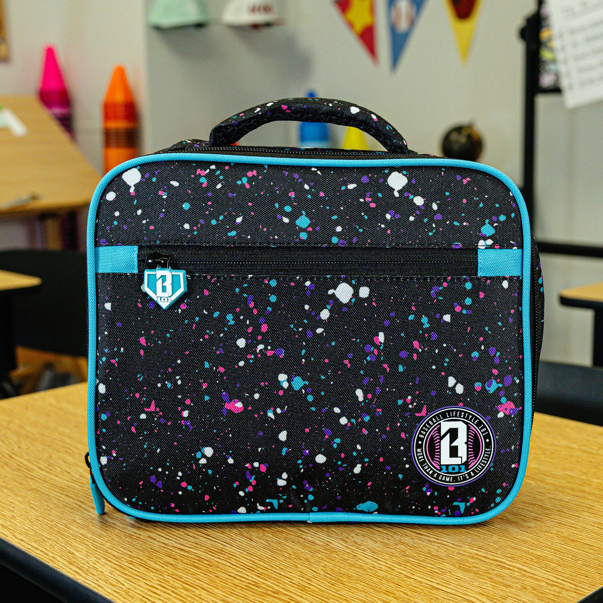 Adult model wearing black lunch box with "Splatter SZN 2" design
