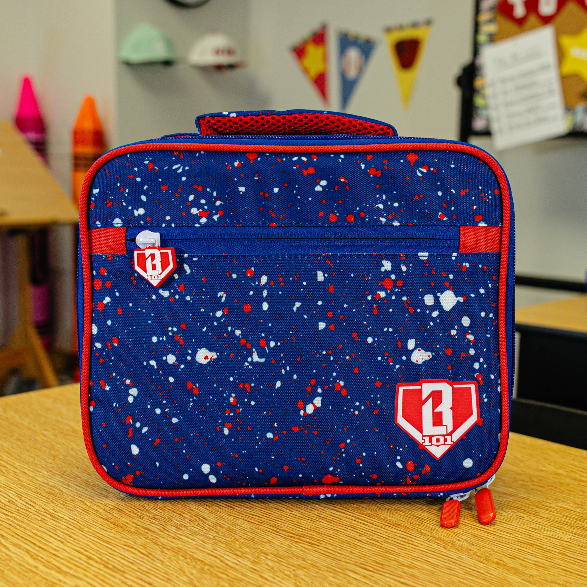 Adult model wearing blue lunch box with "Splatter SZN 2" design