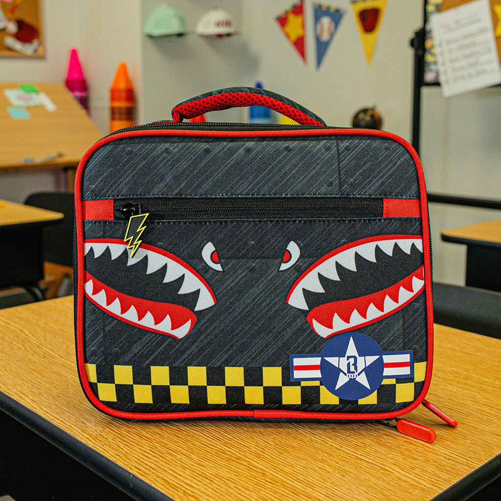 Adult model wearing multi-color lunch box with "Unit 101 SZN 2" design