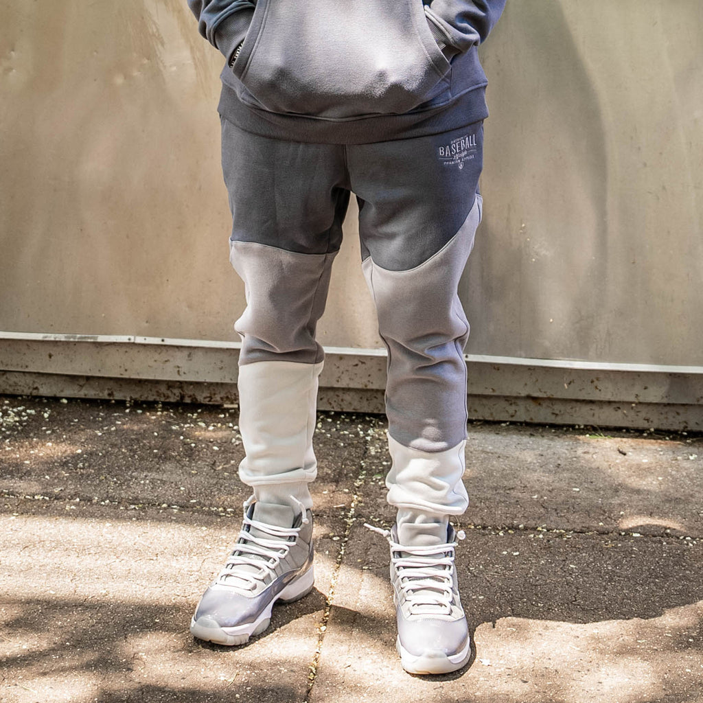 Person wearing a gray and white sweatpants outside