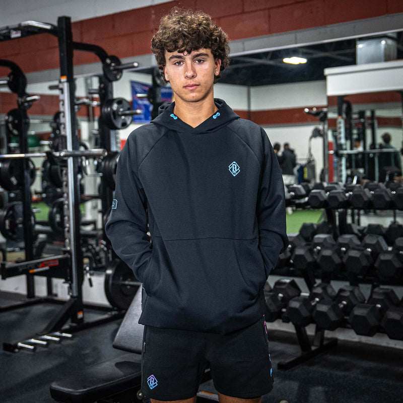 Person wearing a black hoodie and BL101 logo in a gym setting