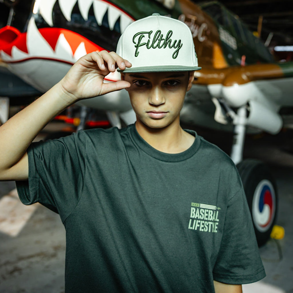 White and olive green snapback hat with Filthy embroidered on the front 
