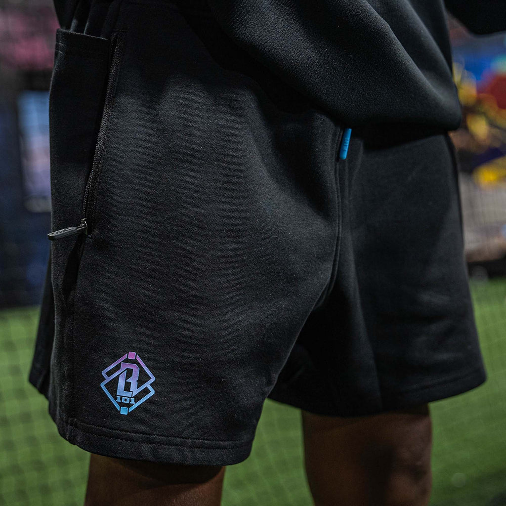 Black shorts with BL101 logo on the back pocket against a blurred background