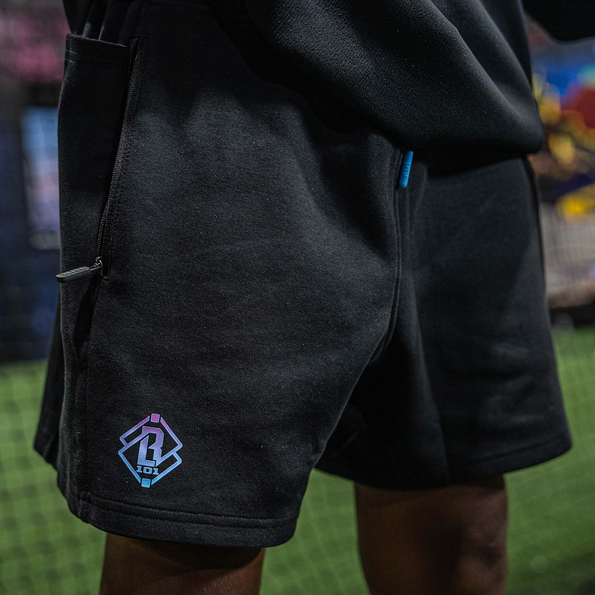 Black shorts with BL101 logo on the back pocket against a blurred background