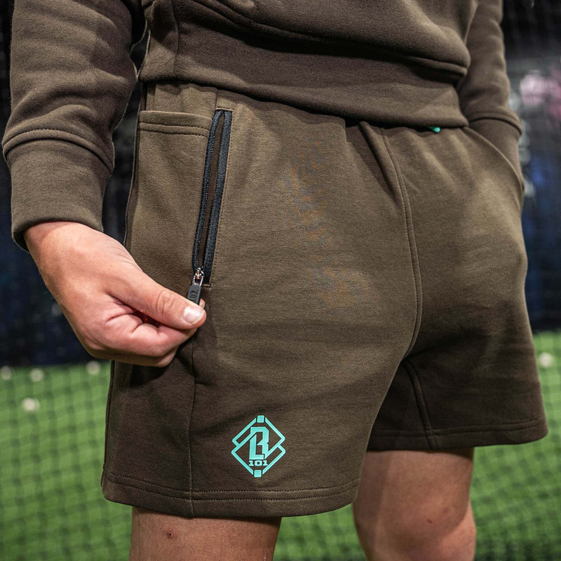 Brown shorts with a green BL101 logo and zipped pocket 