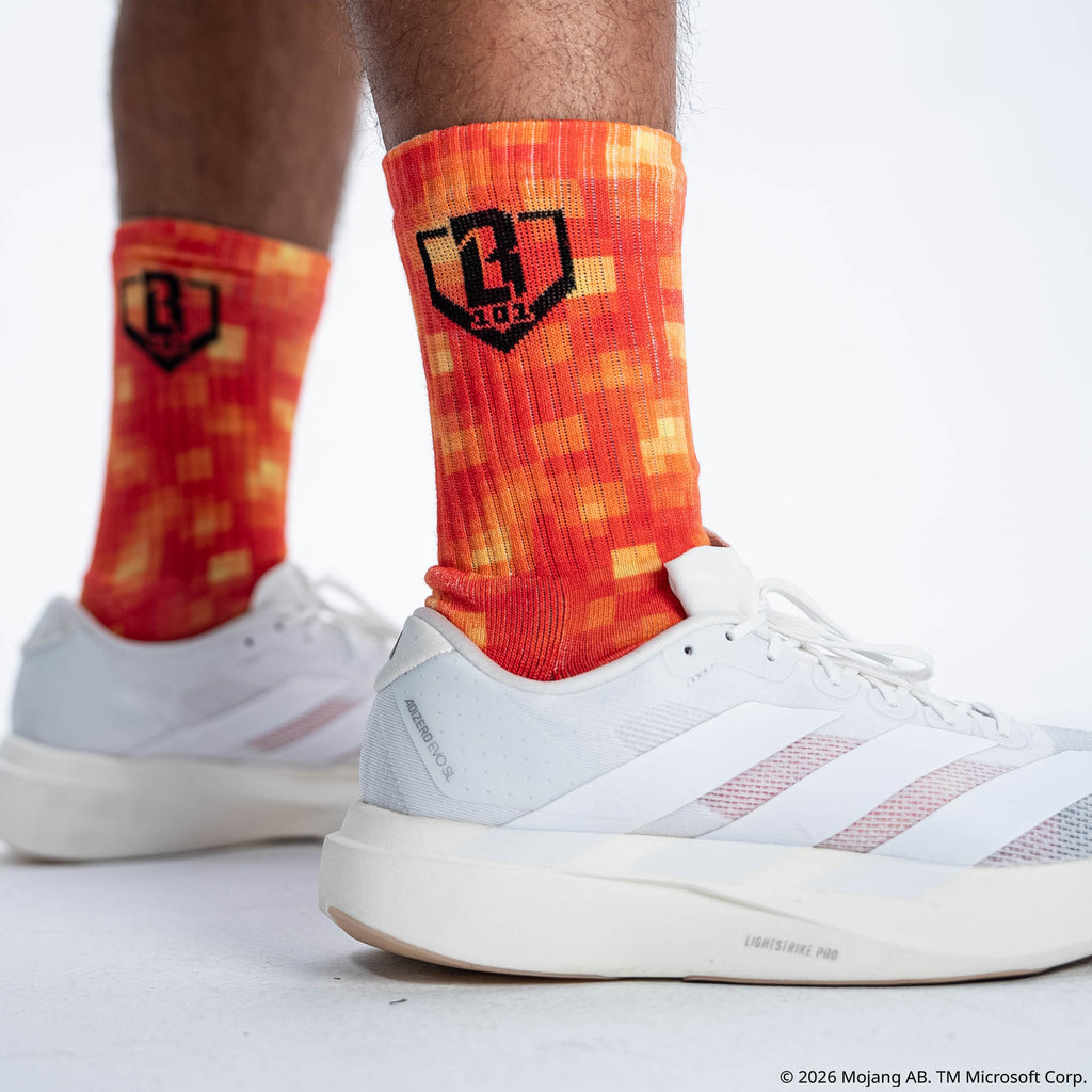 Adult model wearing multi-color socks with "BL101 X Minecraft Performance 3-Pack" design