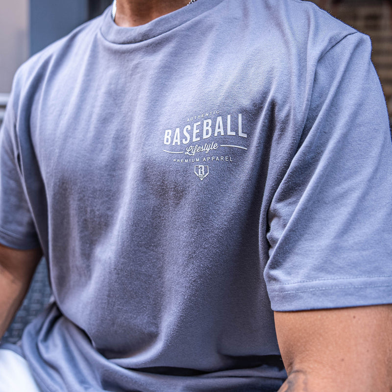 Person wearing a gray t-shirt with 'Baseball Lifestyle' text and logo.