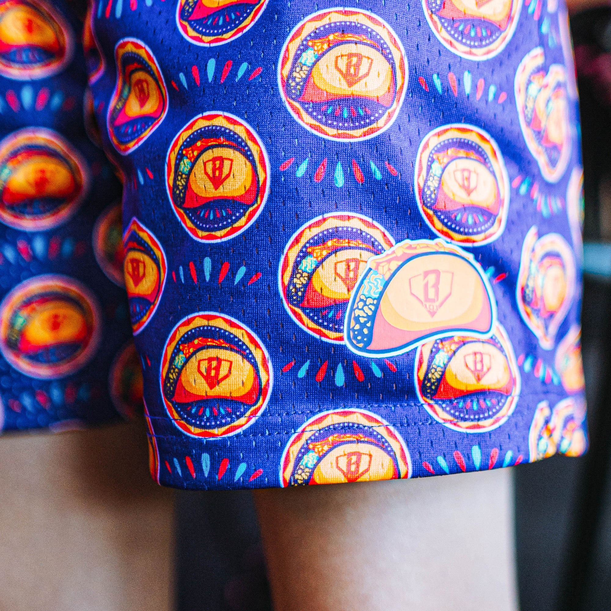close up of purple shorts with colorful taco design 