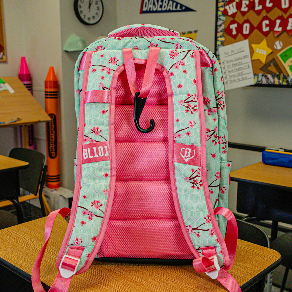 Green backpack with "Cherry Blossoms SZN 2" design — back view