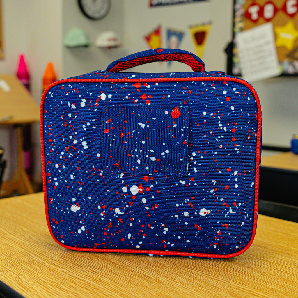 Adult model wearing blue lunch box with "Splatter SZN 2" design