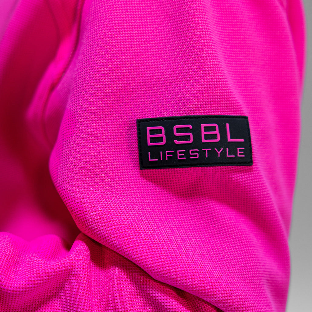 Close-up of a pink fabric with a black label reading 'BSBL Lifestyle'.