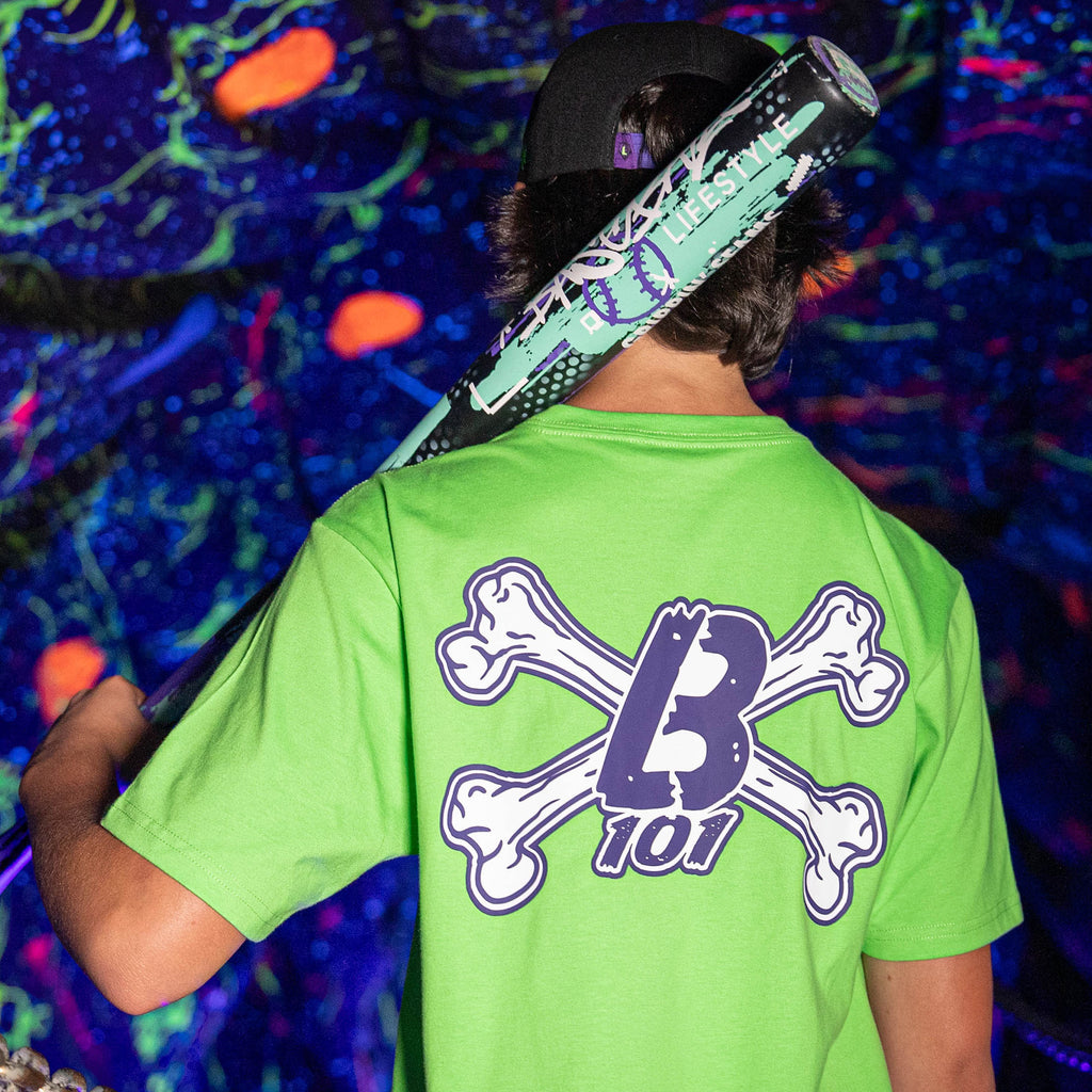 Adult model wearing green Crossbones graphic tee