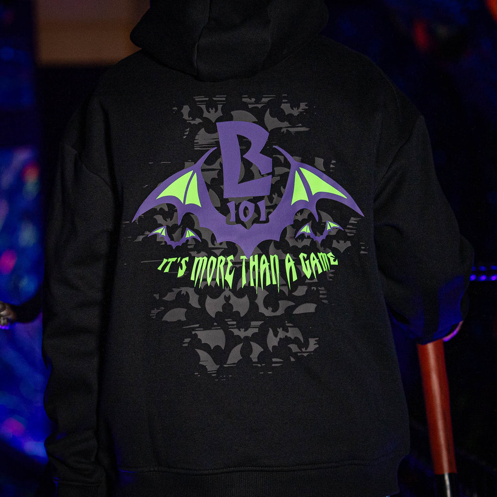 Adult model wearing black Bat Crest hoodie