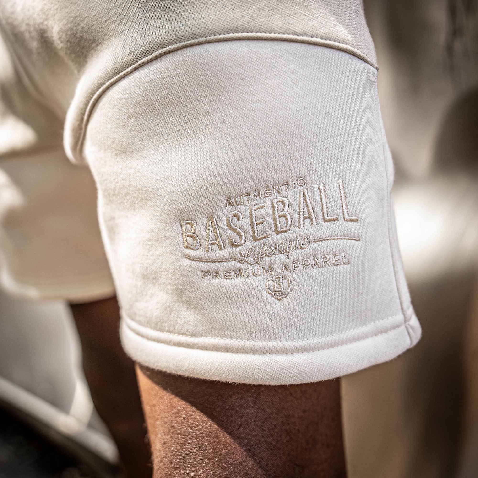 close up of 'Authentic. Baseball Lifestyle PREMIUM APPAREL' on brown and beige shorts