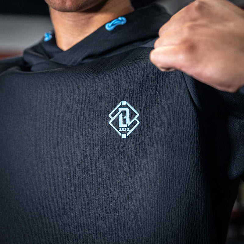Person wearing a black hoodie with a blue BL101 logo on the chest