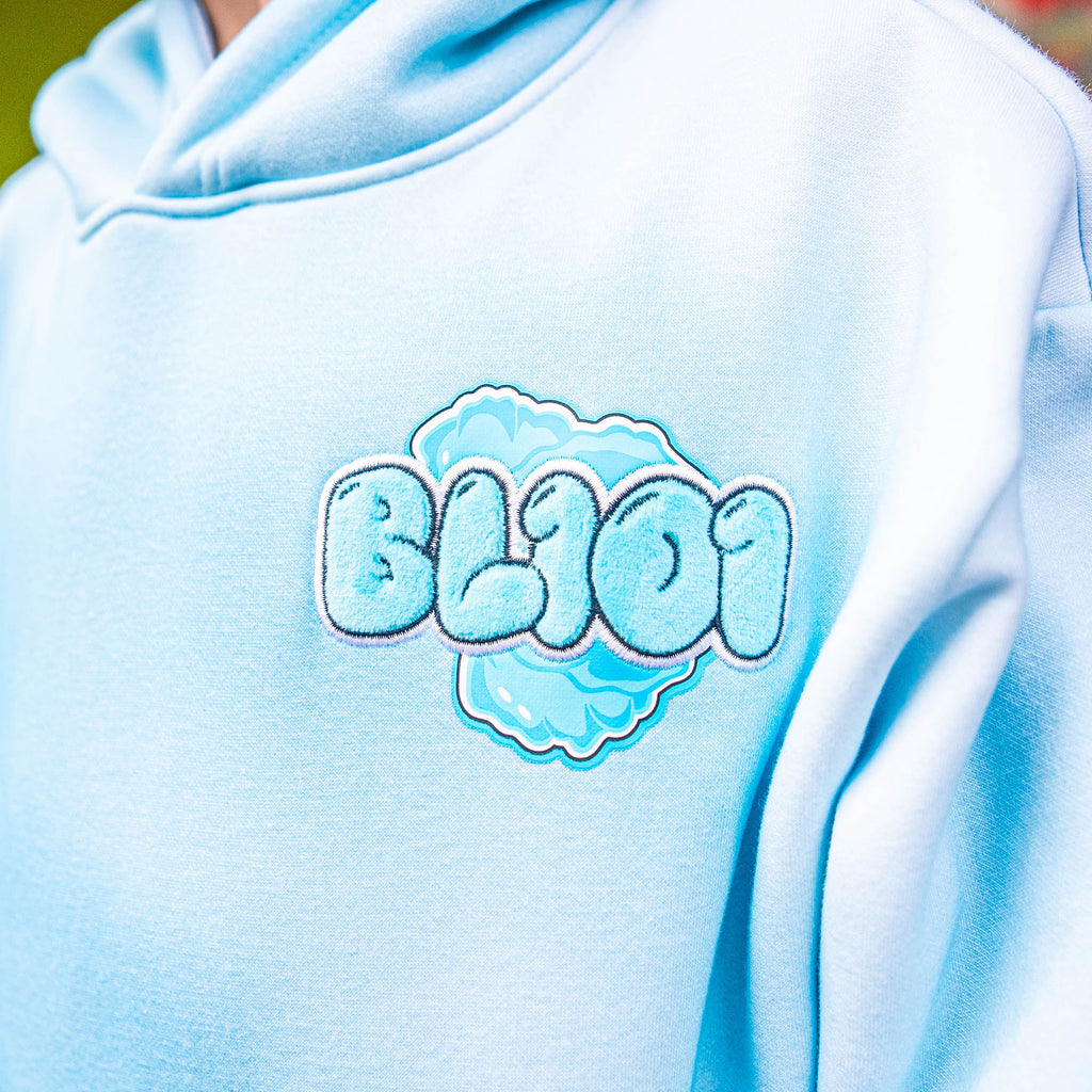 Light blue hoodie with 'BL101' logo on a blurred background