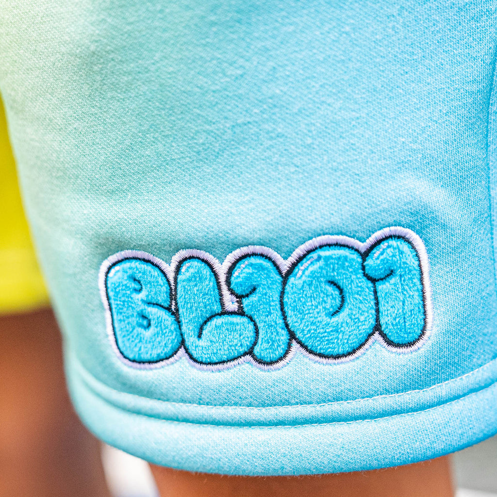 Blue shorts with 'BL101' logo on a blurred background