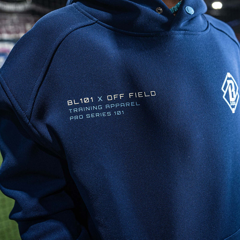 Navy blue hoodie with 'BL101 X OFF FIELD' text and logo on a blurred background