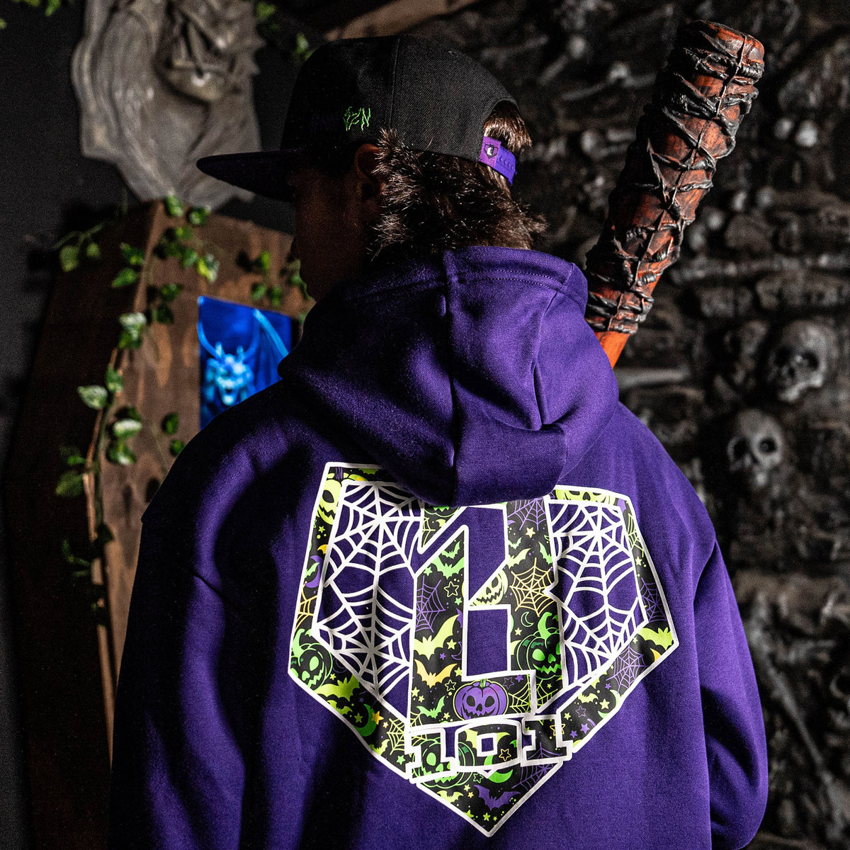 Adult model wearing hoodie with “BL101 Spiderweb” design