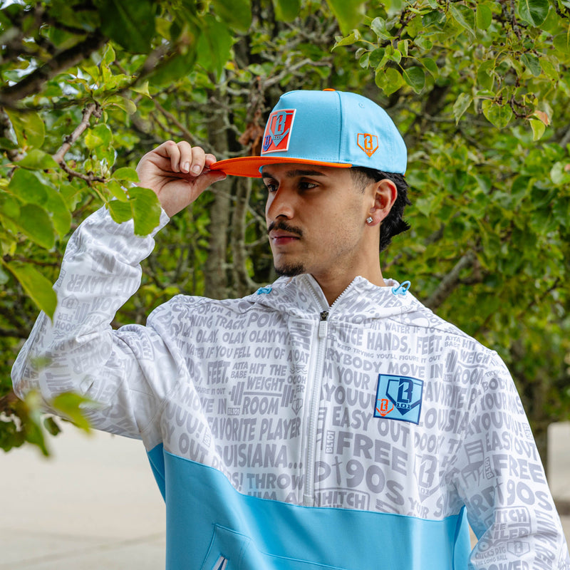 Adult model wearing blue hat with "Trash Talk" design