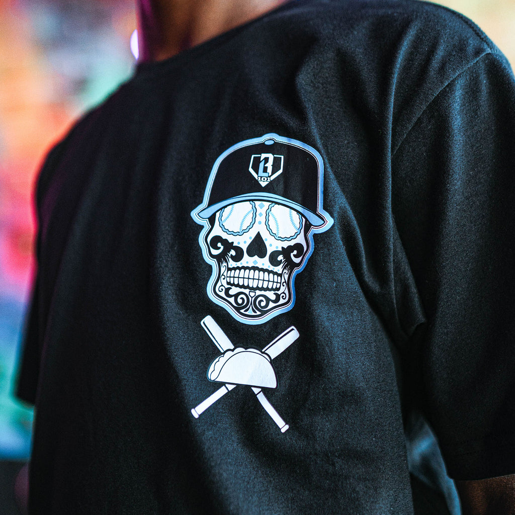 Black t-shirt with a skull and crossbones design on the back, featuring a BL101 cap and baseball bat.