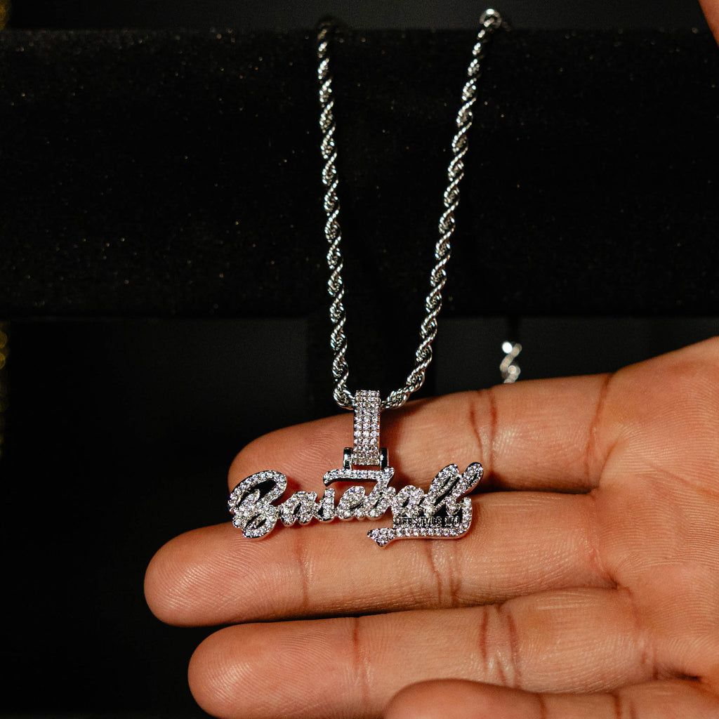 White Gold BL101 Established necklace hanging on a display stand against a black background