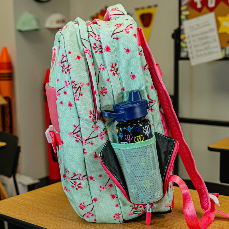 Green backpack with "Cherry Blossoms SZN 2" design — back view