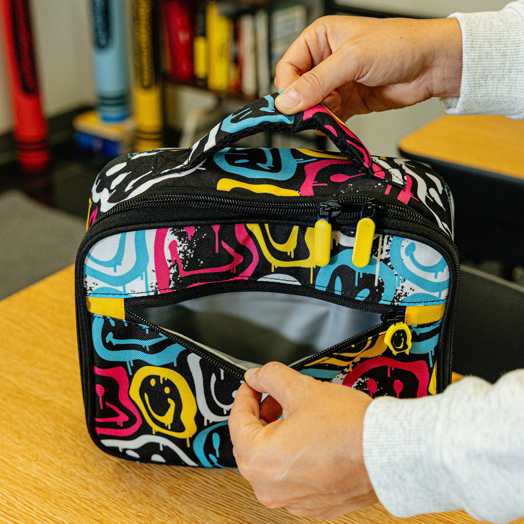 Adult model wearing multi-color lunch box with "Smiley Slugger SZN 2" design