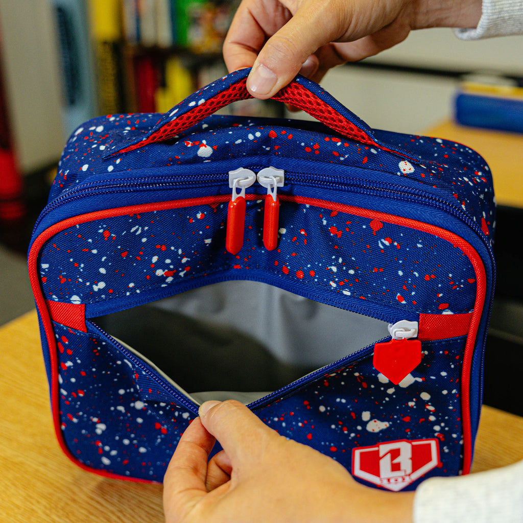 Adult model wearing blue lunch box with "Splatter SZN 2" design