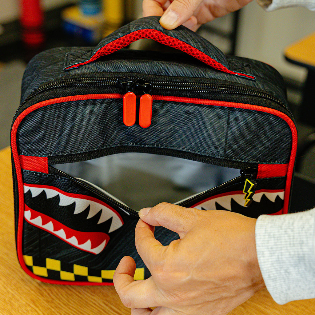 Adult model wearing multi-color lunch box with "Unit 101 SZN 2" design