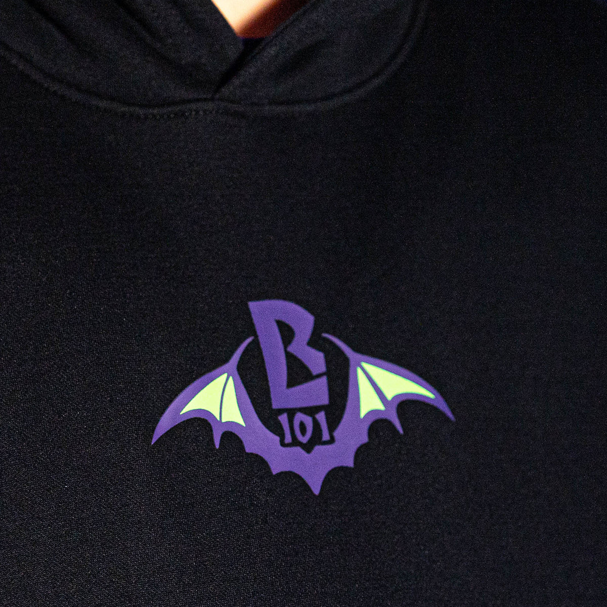 Adult model wearing black Bat Crest hoodie
