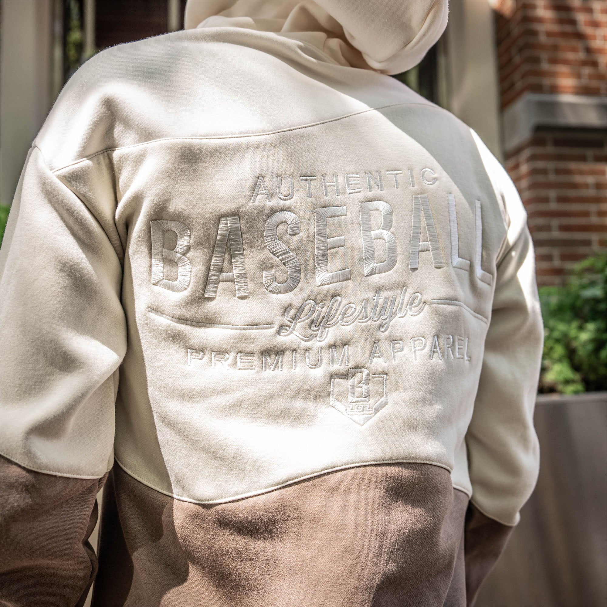 Beige and brown hoodie with 'Authentic Baseball Lifestyle Premium Apparel' text on the back.