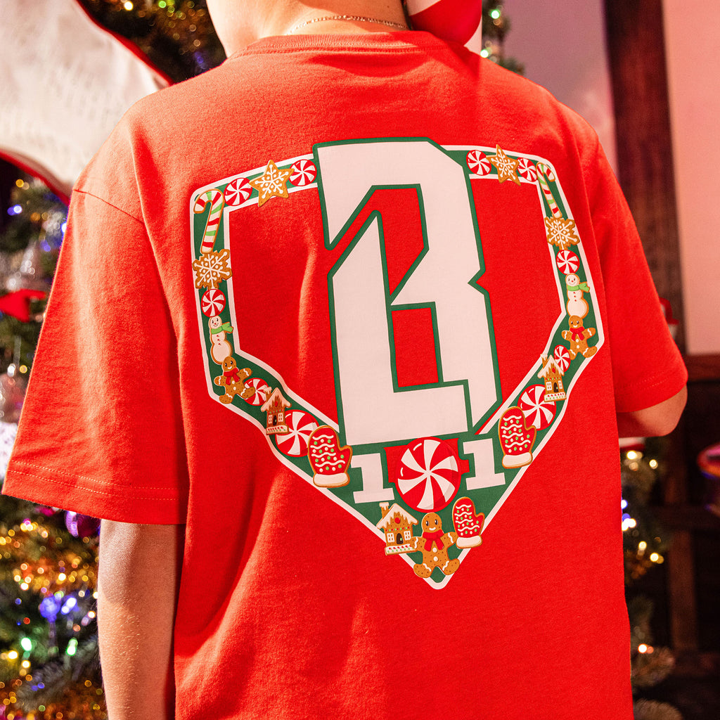 Red t-shirt with a decorative BL101 logo on the back, worn by a person in a festive indoor setting.
