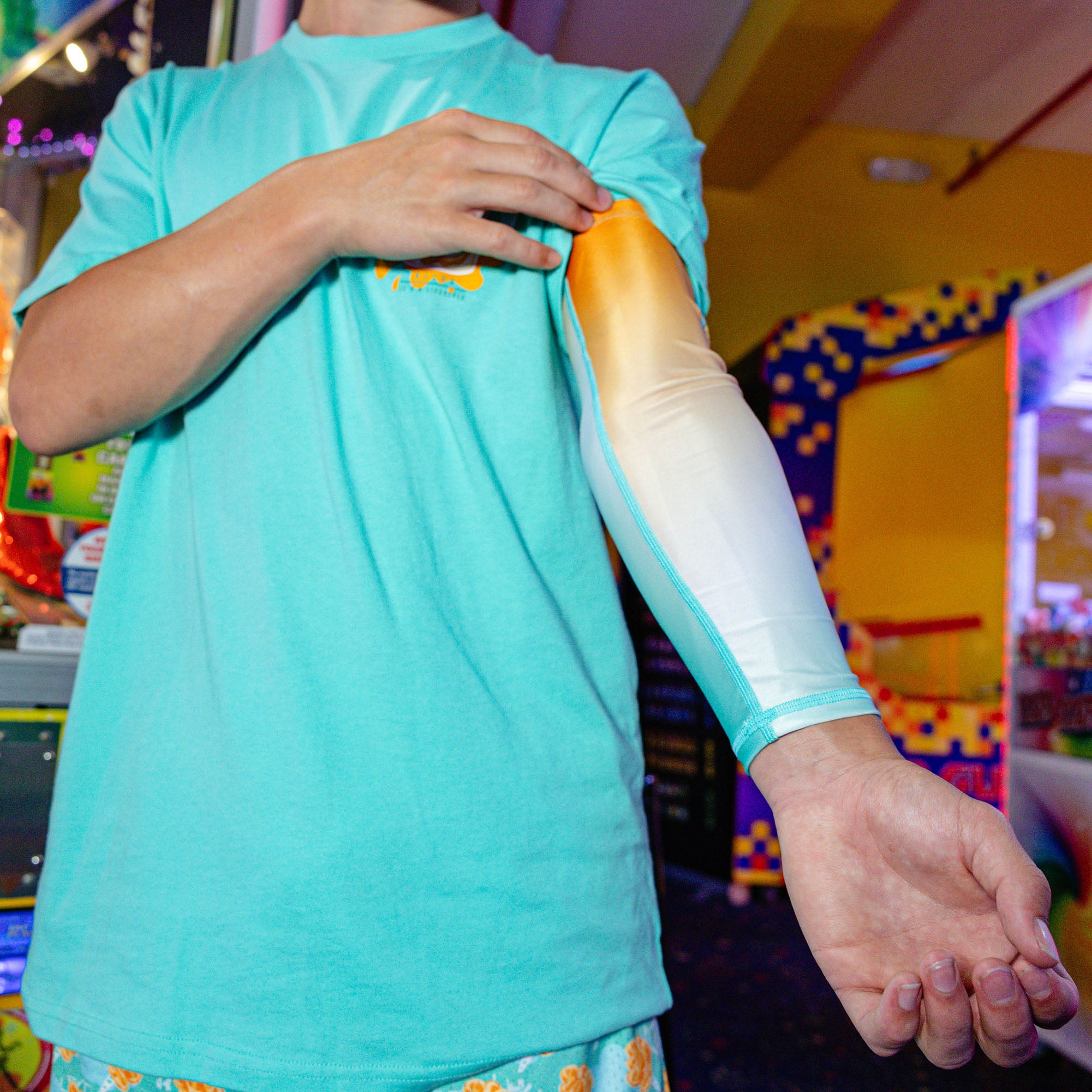 Youth model wearing Cotton Candy Tangerine Freeze youth arm sleeve