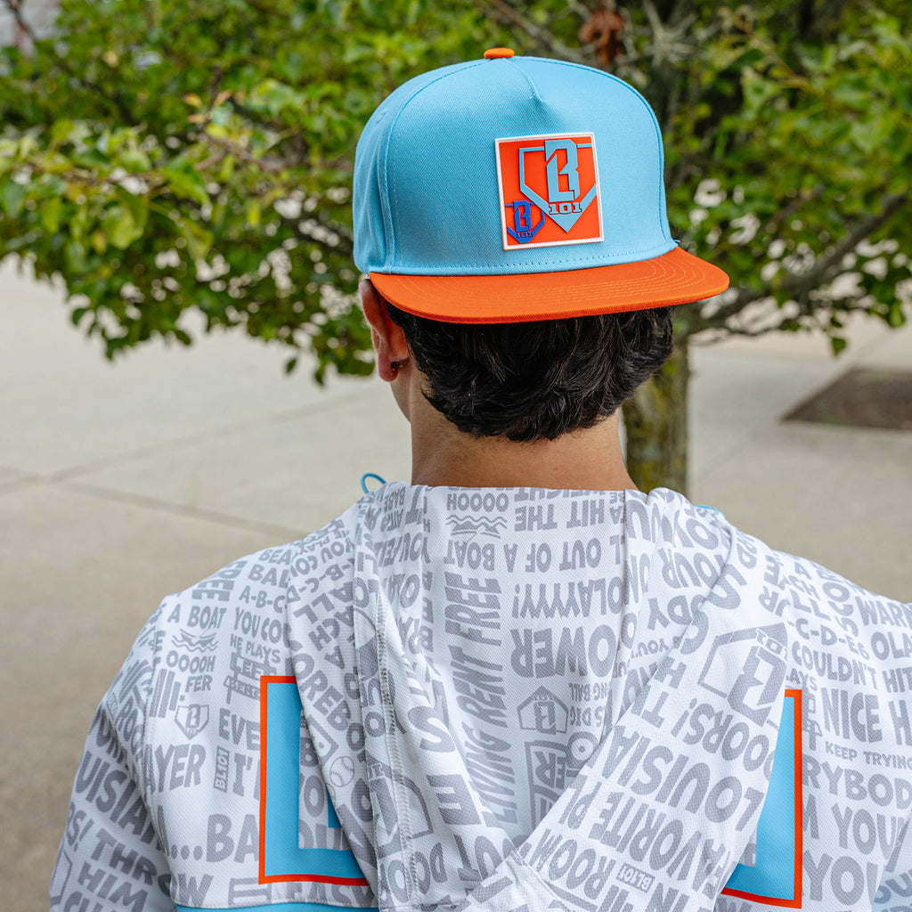 Adult model wearing blue hat with "Trash Talk" design