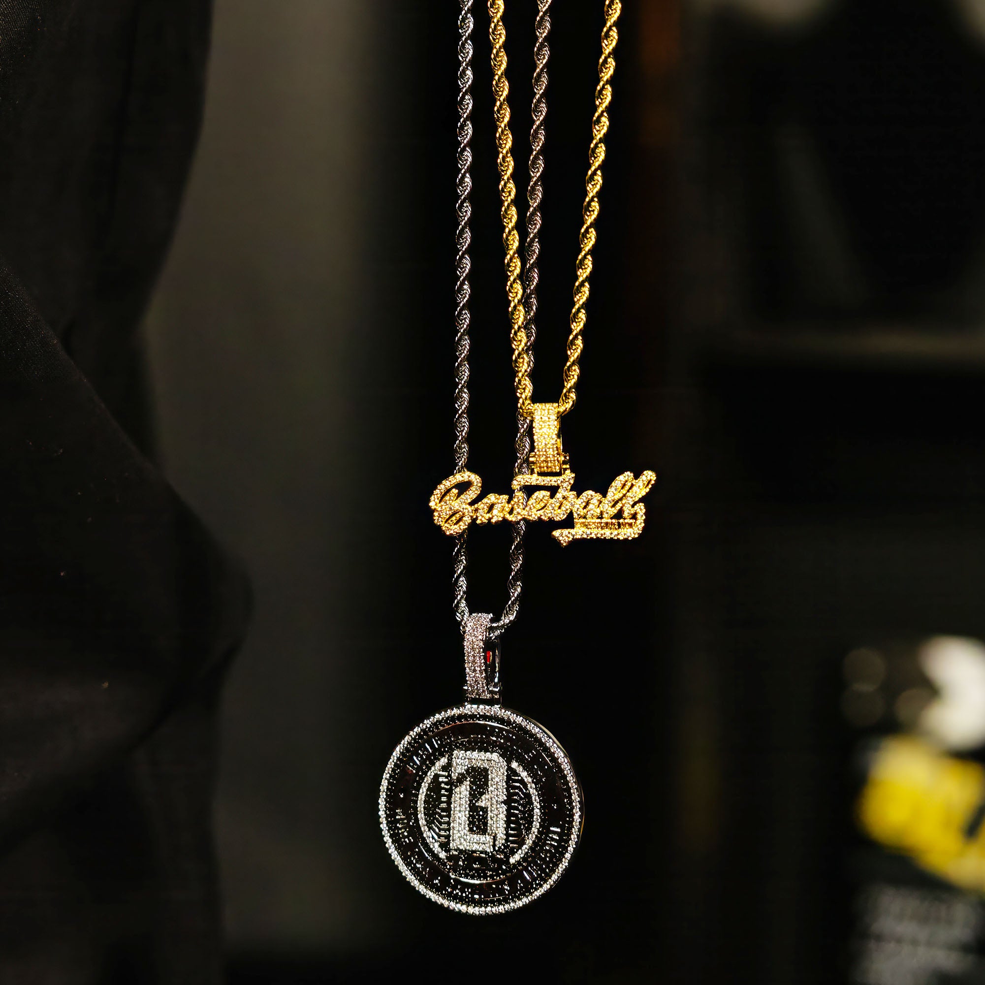 Yellow Gold BL101 Established necklace hanging on a display stand against a black background