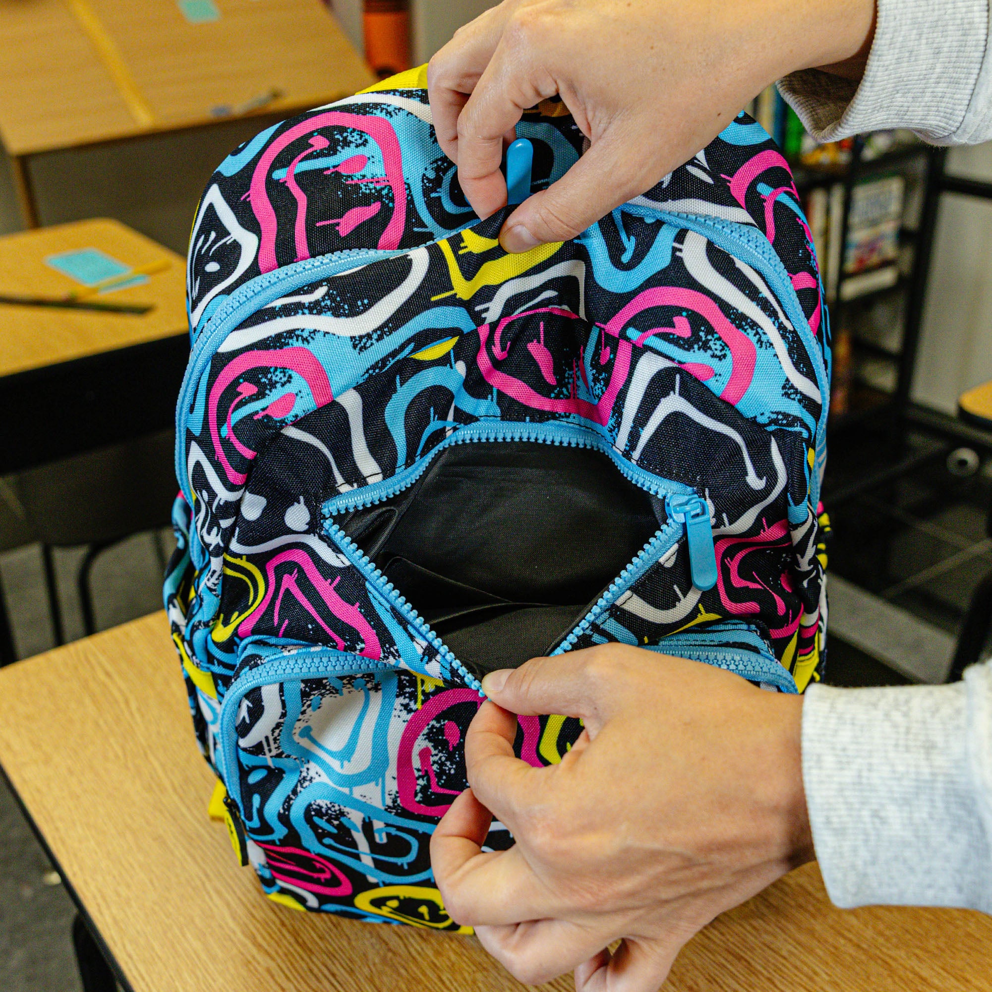 Multi-Color backpack with "Smiley Slugger Rotation" design — back view
