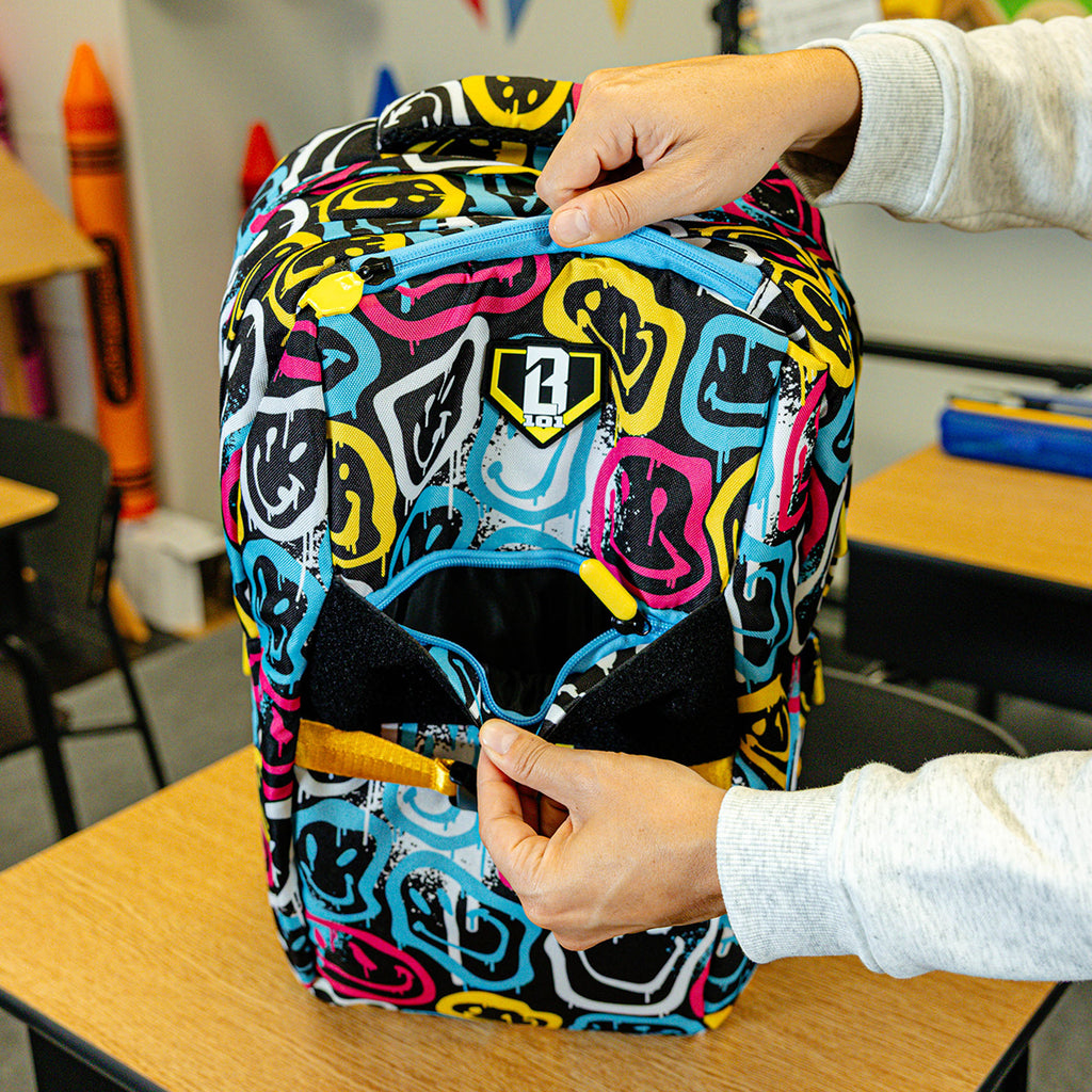 Multi-Color backpack with "Smiley Slugger SZN 2" design — back view